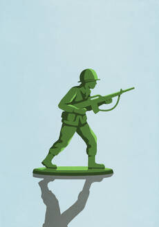 Green soldier with rifle toy on blue background - FSIF06963