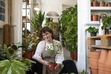 Botanist doing planting sitting at nursery - VRAF00433