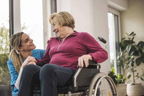Happy home caregiver taking care of senior woman - UUF31187