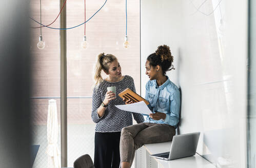 Business colleagues having discussion in office - UUF31279