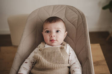 Cute baby girl sitting on bouncer chair - EBBF08780