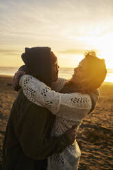 Loving young couple enjoying at beach - ANNF00948