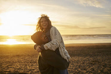 Happy young couple having fun at beach - ANNF00953