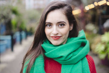 Smiling woman with brown hair wearing green scarf - AMWF02003