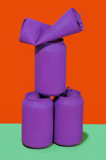 Purple cans stacked on vibrant color background - RDTF00006