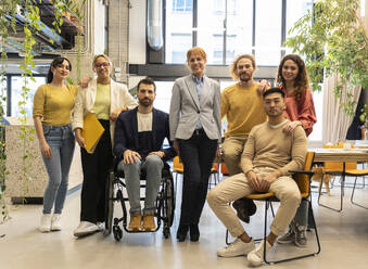 Multiracial business colleagues posing together at co-working space - JCCMF11282