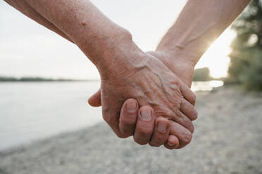 Mother and son holding hands at beach on sunny day - KVBF00014