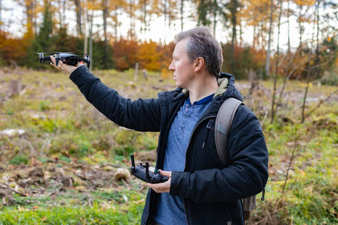 Mann lässt Drohne im Wald starten - ELMF00001