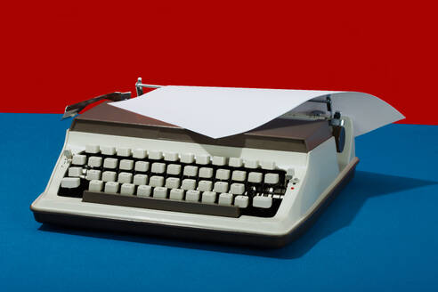 Retro typewriter with paper against colored background - RDTF00013