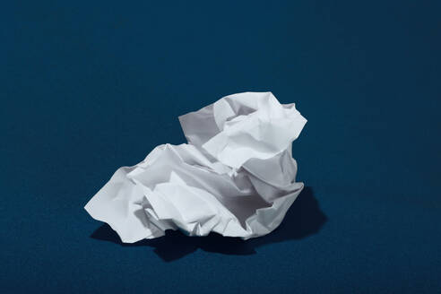 White crumpled paper over blue background - RDTF00019