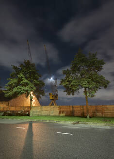 Netherlands, South Holland, Rotterdam, Old harbor seen from adjacent road at night - MKJF00032