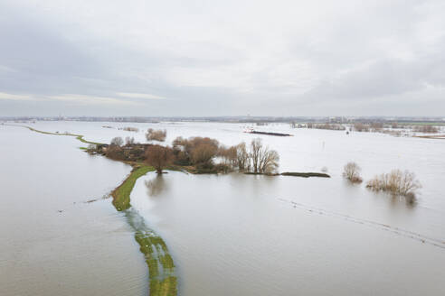 Netherlands, Aerial view of river Waal flooding surrounding land after prolonged rainfall - MKJF00043