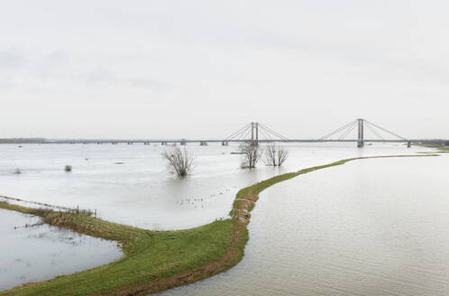 Netherlands, Aerial view of river Waal flooding surrounding land after prolonged rainfall - MKJF00045