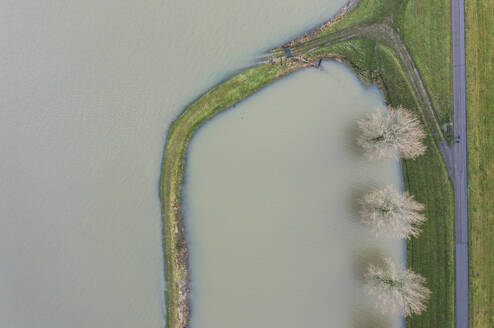 Netherlands, Aerial view of river Waal flooding surrounding land after prolonged rainfall - MKJF00046