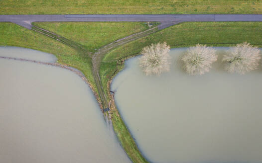 Netherlands, Aerial view of river Waal flooding surrounding land after prolonged rainfall - MKJF00048