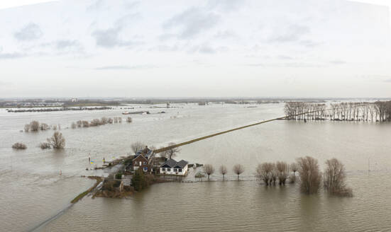 Netherlands, Aerial view of river Waal flooding surrounding land after prolonged rainfall - MKJF00049