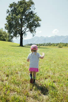 Girl walking on grass in meadow at Vorarlberg, Austria - AIF00791