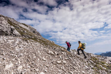 Hiker couple climbing up on mountain at Bavarian Alps - UUF31461