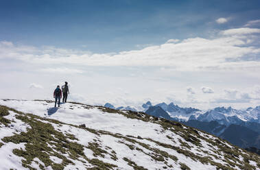 Hiker couple standing on mountain at Bavarian Alps in Germany - UUF31470