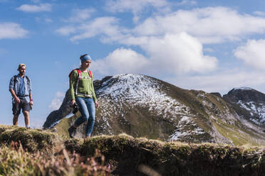 Young couple hiking on mountain at Bavarian Alps in Germany - UUF31471