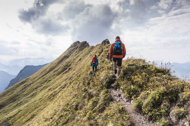 Couple walking on mountain at Bavarian Alps in Germany - UUF31474