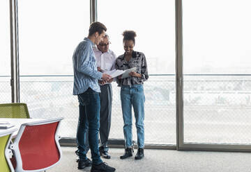 Business colleagues discussing strategies in office - UUF31506