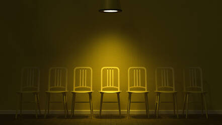 3D render of row of empty chairs illuminated by light fixture - UWF01603