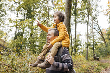 Vater trägt Sohn auf den Schultern im Herbstwald - ELMF00017