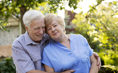 Happy elderly couple spending leisure time in garden - MBLF00282