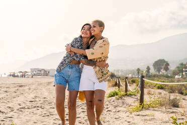 Beautiful multiethnic lesbian couple of lovers dating outdoors - LGBT people bonding and spending time together, concepts about LGBTQ community, diversity, love and lifestyle - DMDF10112