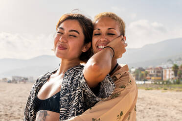 Beautiful multiethnic lesbian couple of lovers dating outdoors - LGBT people bonding and spending time together, concepts about LGBTQ community, diversity, love and lifestyle - DMDF10136