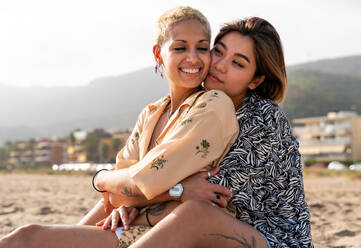 Beautiful multiethnic lesbian couple of lovers dating outdoors - LGBT people bonding and spending time together, concepts about LGBTQ community, diversity, love and lifestyle - DMDF10165