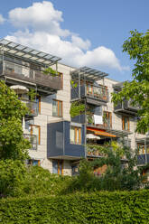 Balconies on green building in Munich, Bavaria, Germany - MAMF02947