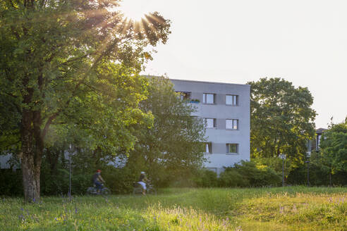 Modern building behind trees in Munich, Bavaria, Germany - MAMF02948