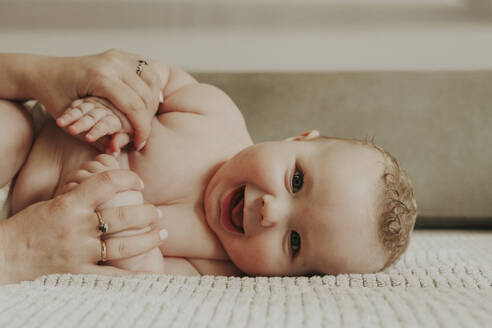 Shirtless happy boy with mother at home - OSF02439