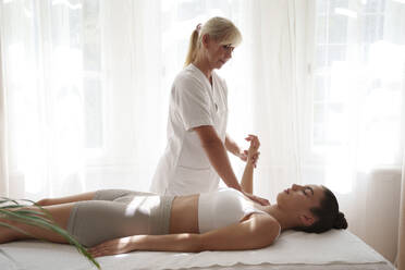 Osteopath treating patient in rehabilitation center - AAZF01577