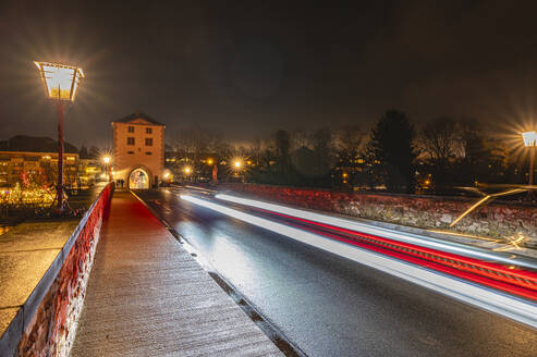 Germany, Hesse, Limburg an der Lahn, Vehicle light trails along asphalt road at night - MHF00772