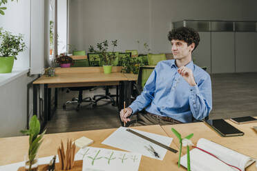 Engineer sitting at desk in office - YTF01926