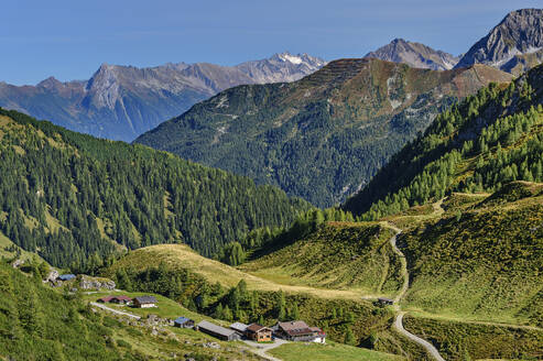 Austria, Tyrol, View of Junsbergalm dairy and surrounding mountains in summer - ANSF00756