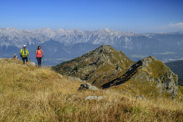 Austria, Tyrol, Man and woman hiking toward Rosskopf peak in Tux Alps - ANSF00760