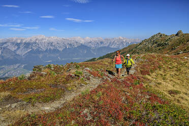 Austria, Tyrol, Man and woman hiking toward Rosskopf peak in Tux Alps - ANSF00761