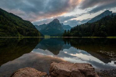 Serene lake at dusk with mountain reflections and a tranquil atmosphere in the Swiss Alps. - ADSF53180