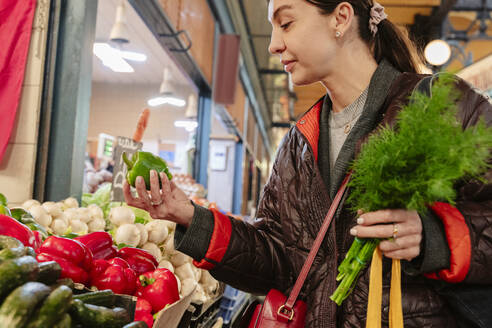 Woman buying vegetables in market - OSF02440