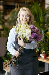 Happy florist holding bunch of flowers - SANF00211