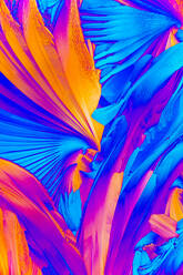 A striking micrograph featuring salicylic acid crystals, resembling vibrant petals in rich blue and orange hues - ADSF53310