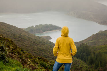 Woman standing on a top of a clif and enjoying the view - INGF12958