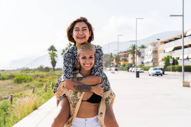 Beautiful multiethnic lesbian couple of lovers dating outdoors - LGBT people bonding and spending time together, concepts about LGBTQ community, diversity, love and lifestyle - DMDF10266