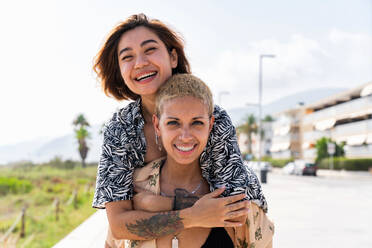 Beautiful multiethnic lesbian couple of lovers dating outdoors - LGBT people bonding and spending time together, concepts about LGBTQ community, diversity, love and lifestyle - DMDF10273