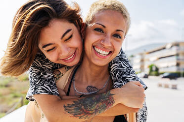 Beautiful multiethnic lesbian couple of lovers dating outdoors - LGBT people bonding and spending time together, concepts about LGBTQ community, diversity, love and lifestyle - DMDF10279