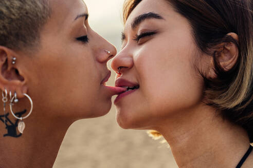 Beautiful multiethnic lesbian couple of lovers dating outdoors - LGBT people bonding and spending time together, concepts about LGBTQ community, diversity, love and lifestyle - DMDF10332